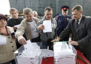 People cast ballots at a polling station during the referendum on the status of Donetsk and Luhansk regions, in Moscow